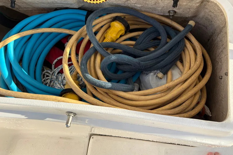 Tru Blu Yacht Photos Pics Storage compartment with coiled hoses and ropes on a 2010 Hunter 39 boat.