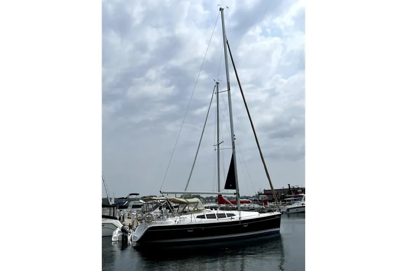 Tru Blu Yacht Photos Pics 2010 Hunter 39 sailboat docked in marina under cloudy sky.