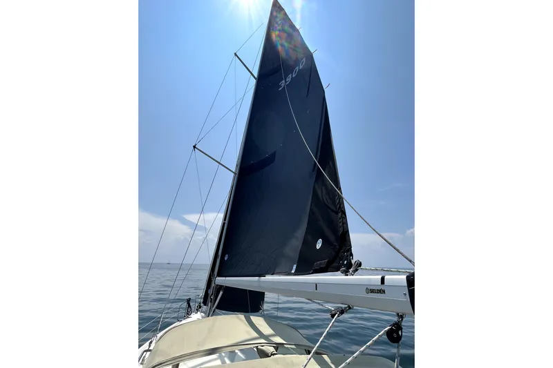 Tru Blu Yacht Photos Pics Sailing on a 2010 Hunter 39 yacht with black sails under a clear blue sky.