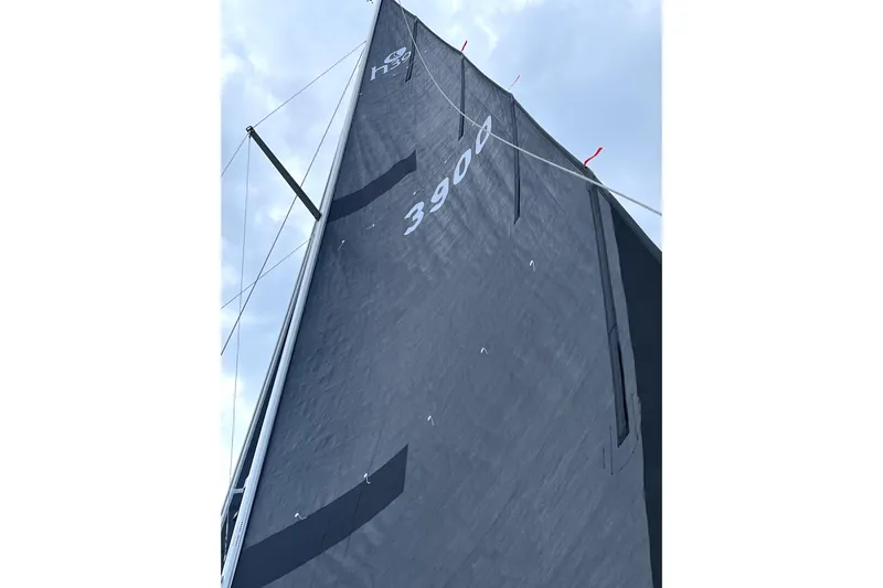 Tru Blu Yacht Photos Pics Sail of a 2010 Hunter 39 yacht against a cloudy sky.