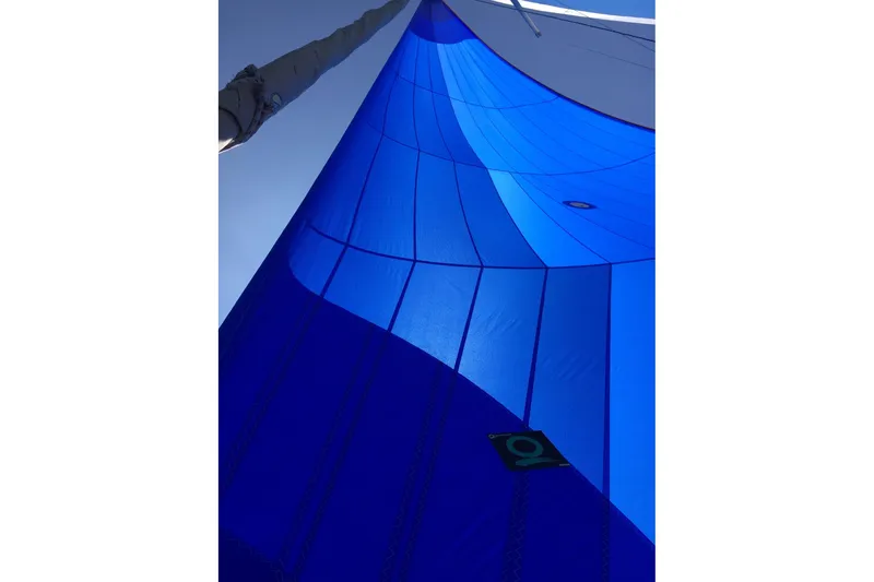 Tru Blu Yacht Photos Pics Blue sail of a 2010 Hunter 39 yacht against a clear sky.