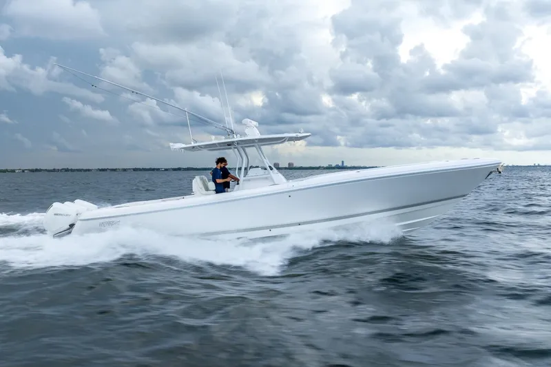  Yacht Photos Pics 2022 Intrepid 375 Nomad FE boat cruising on open water under cloudy skies.