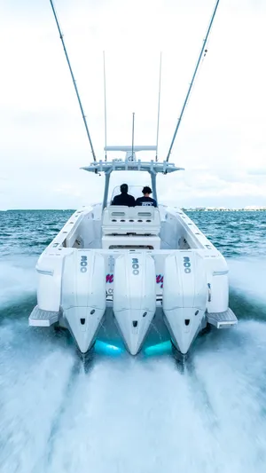  Yacht Photos Pics 2022 Intrepid 375 Nomad FE boat with triple outboard engines cruising on open water.