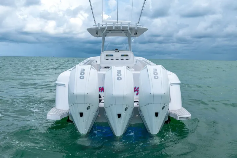  Yacht Photos Pics 2022 Intrepid 375 Nomad FE boat with triple outboard engines on the water.