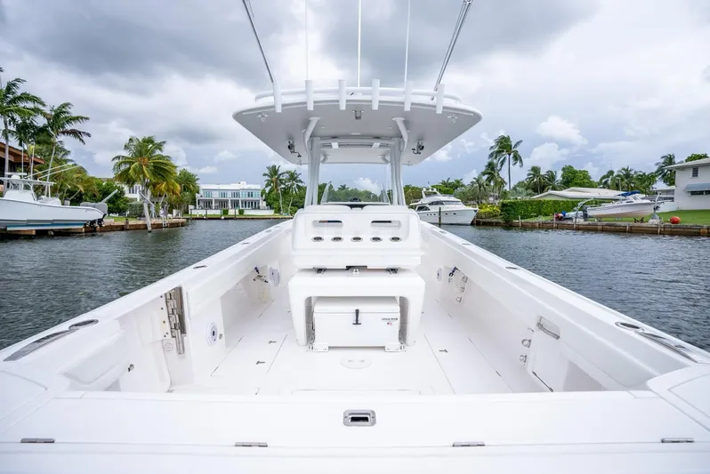  Yacht Photos Pics 2022 Intrepid 375 Nomad FE boat on a calm waterway with palm trees.