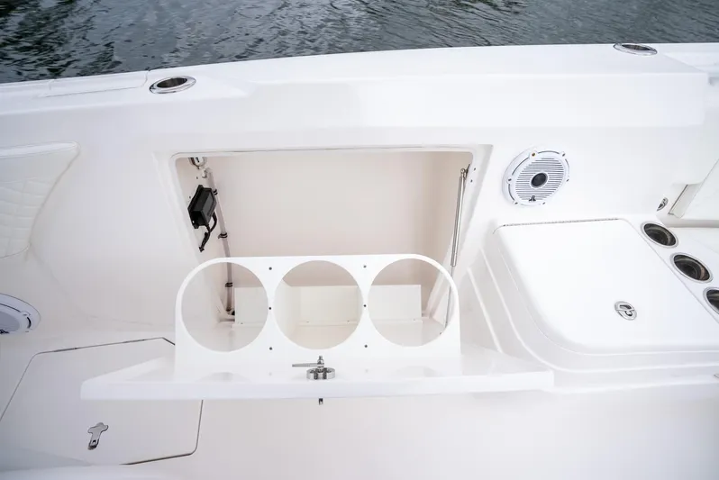  Yacht Photos Pics 2022 Intrepid 375 Nomad FE boat storage compartment and cup holders.