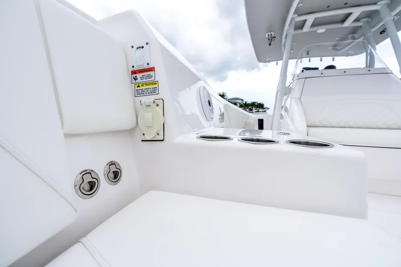  Yacht Photos Pics 2022 Intrepid 375 Nomad FE boat interior with cup holders and seating.