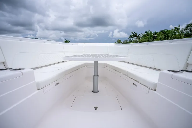  Yacht Photos Pics 2022 Intrepid 375 Nomad FE boat interior with seating and table.