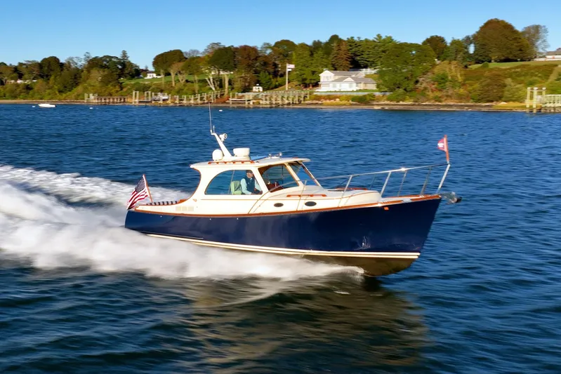 Timeless (name Reserved) Yacht Photos Pics 2015 Hinckley Picnic Boat MK III cruising on a scenic waterway.