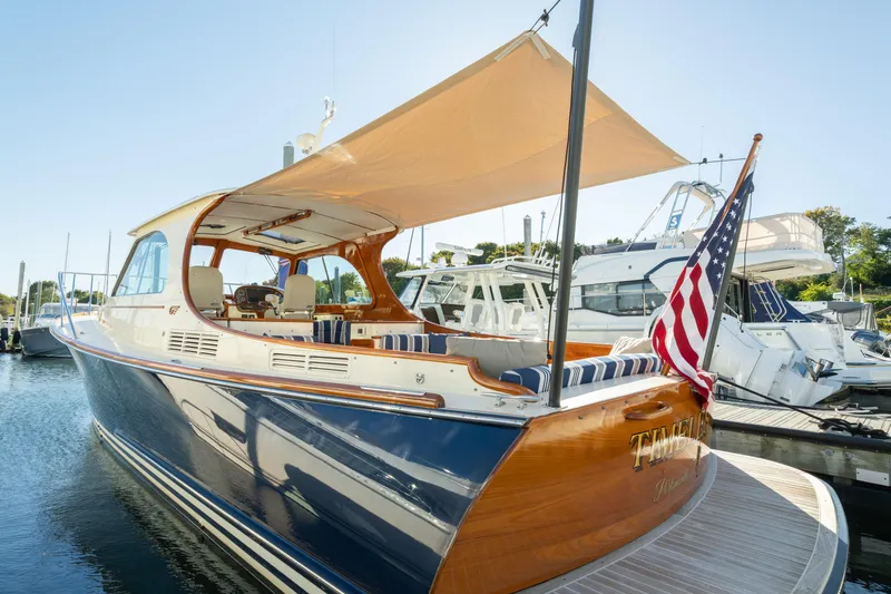 Timeless (name Reserved) Yacht Photos Pics 2015 Hinckley Picnic Boat MK III docked with American flag and sunshade.