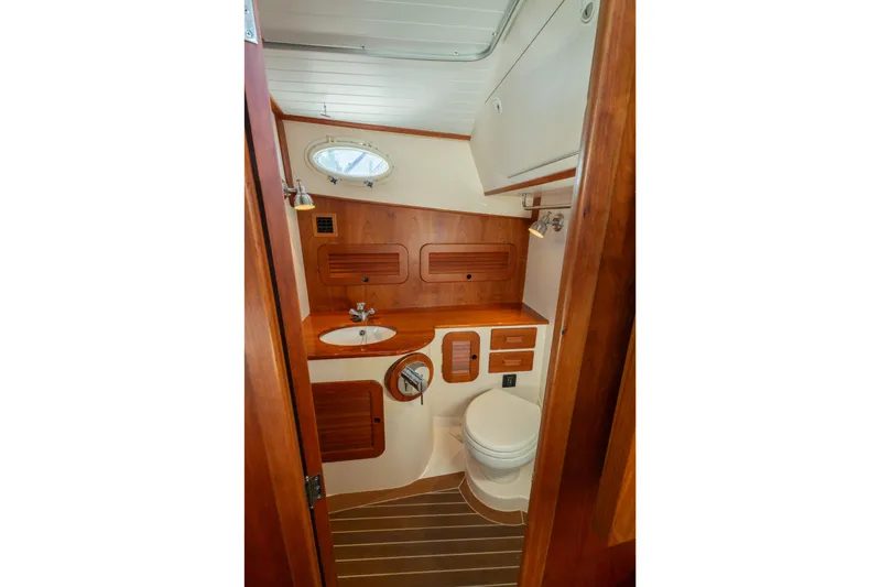 Timeless (name Reserved) Yacht Photos Pics 2015 Hinckley Picnic Boat MK III bathroom with wooden cabinetry and compact design.