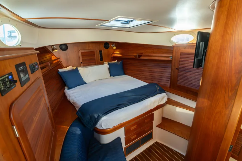 Timeless (name Reserved) Yacht Photos Pics Luxurious 2015 Hinckley Picnic Boat MK III cabin with wood interior and cozy bed.