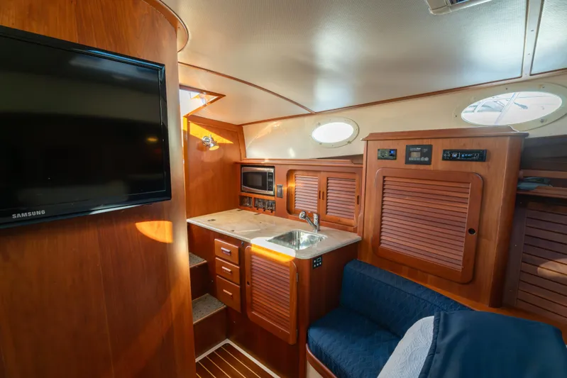Timeless (name Reserved) Yacht Photos Pics Interior of 2015 Hinckley Picnic Boat MK III with wood finish and modern amenities.