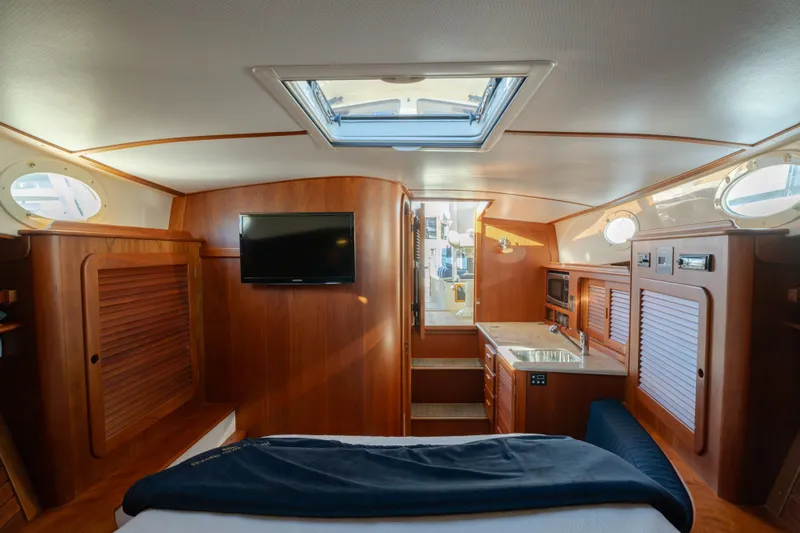 Timeless (name Reserved) Yacht Photos Pics Luxurious interior of 2015 Hinckley Picnic Boat MK III with wood finish and modern amenities.