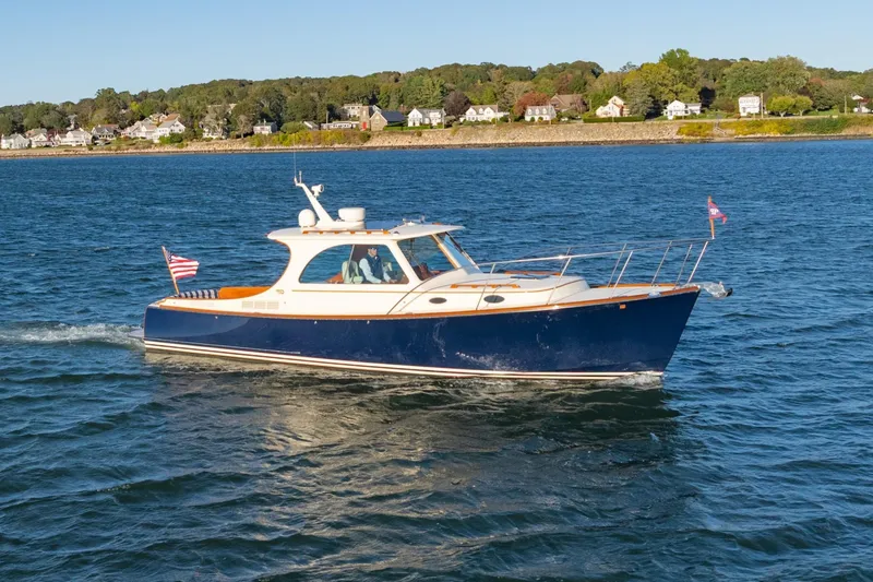 Timeless (name Reserved) Yacht Photos Pics 2015 Hinckley Picnic Boat MK III cruising on a scenic waterway.