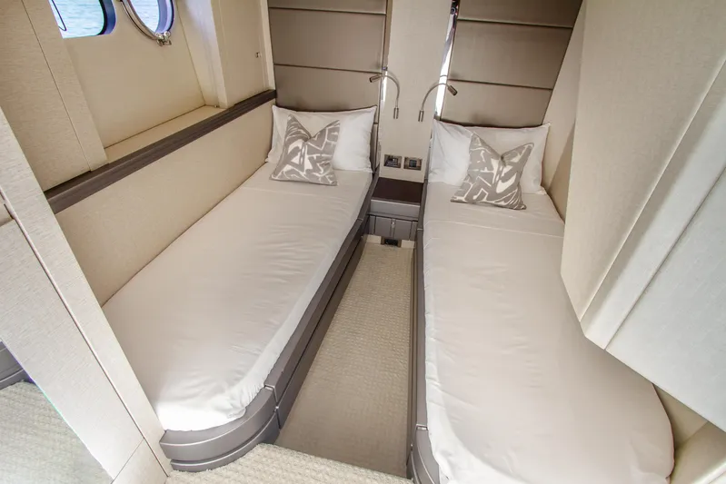 Outlaw Yacht Photos Pics Twin cabin interior of 2015 Sunseeker Manhattan 55 yacht, featuring modern design and comfortable bedding.