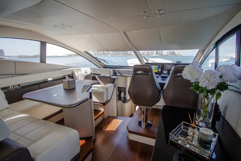 Outlaw Yacht Photos Pics Luxurious interior of 2015 Sunseeker Manhattan 55 yacht with elegant seating and modern helm.