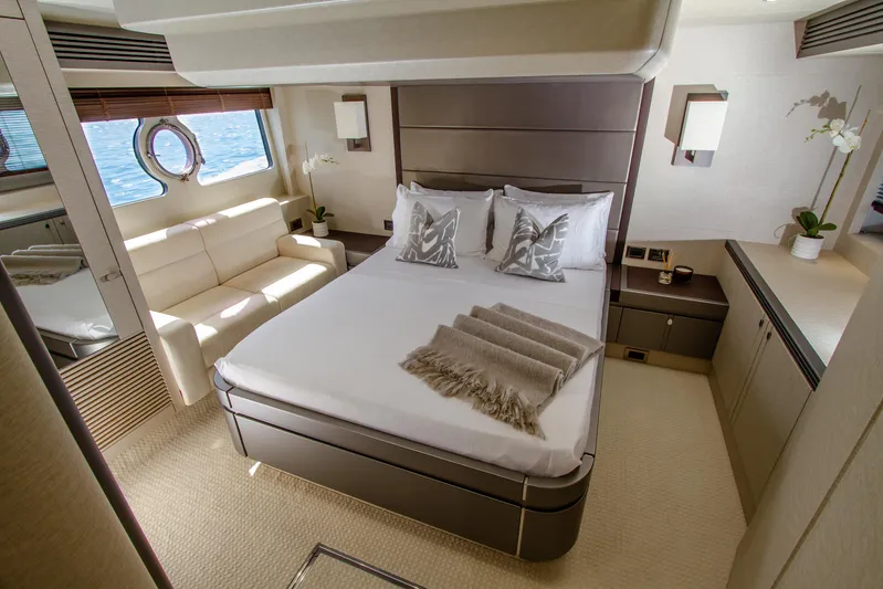 Outlaw Yacht Photos Pics Luxurious bedroom interior of 2015 Sunseeker Manhattan 55 yacht with elegant decor and ocean view.