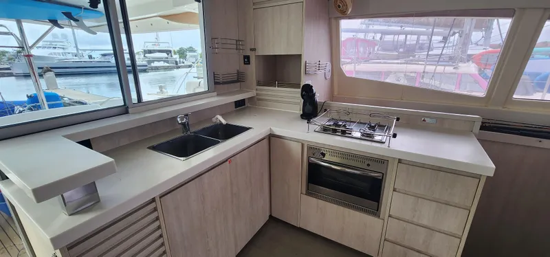 Jolly Dacha Yacht Photos Pics Modern kitchen in a 2015 Leopard 48 yacht with sleek countertops and appliances.