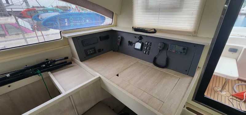 Jolly Dacha Yacht Photos Pics Interior of a 2015 Leopard 48 yacht with navigation controls and wooden finish.