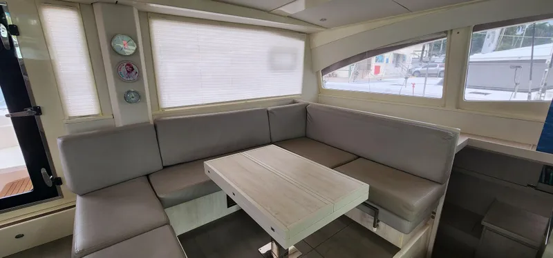 Jolly Dacha Yacht Photos Pics Luxurious interior of 2015 Leopard 48 yacht with modern seating and table.