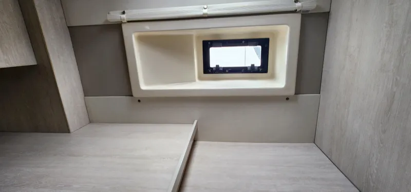 Jolly Dacha Yacht Photos Pics Interior of 2015 Leopard 48 yacht cabin with window and wooden finish.