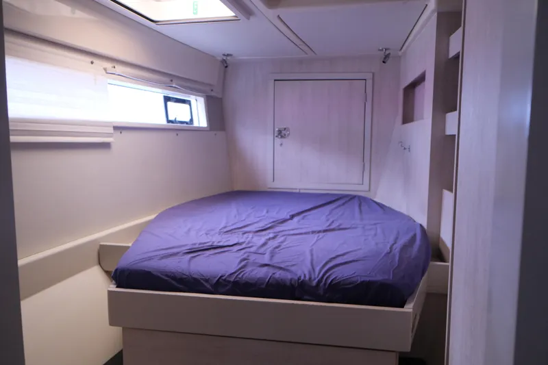 Jolly Dacha Yacht Photos Pics Cozy bedroom in 2015 Leopard 48 yacht with blue bedding and natural light.