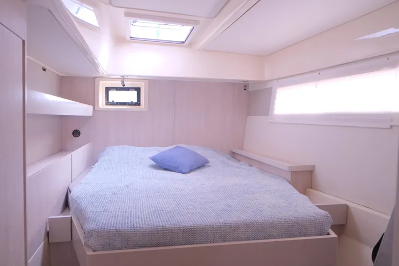 Jolly Dacha Yacht Photos Pics Cozy bedroom in 2015 Leopard 48 yacht with skylight and blue pillow.