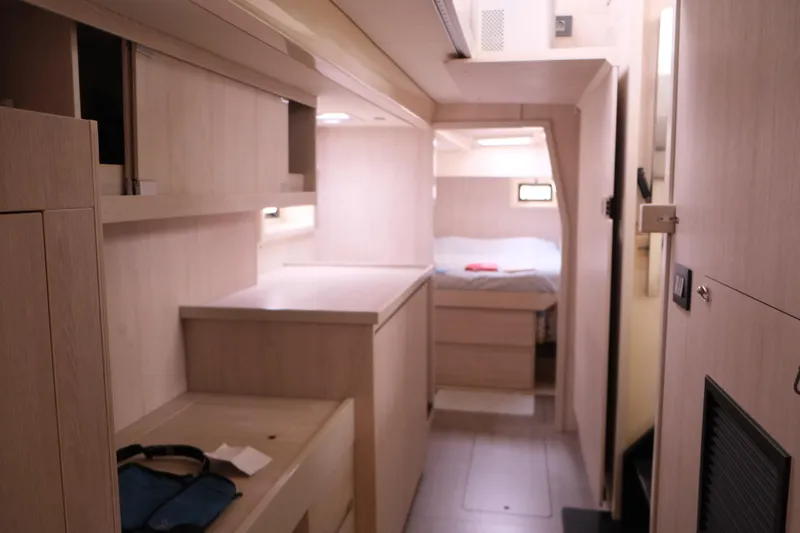 Jolly Dacha Yacht Photos Pics Interior of 2015 Leopard 48 yacht, featuring modern wood cabinetry and cozy sleeping area.