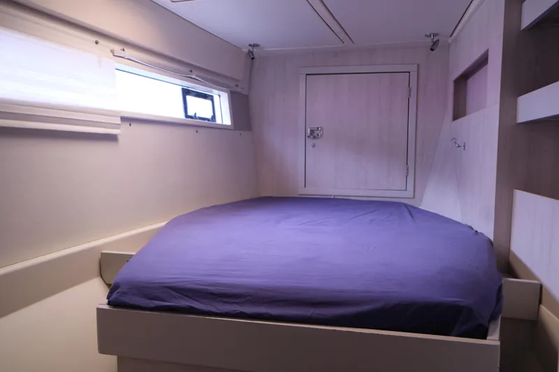 Jolly Dacha Yacht Photos Pics Cozy cabin interior of 2015 Leopard 48 yacht with a comfortable bed.