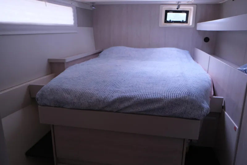 Jolly Dacha Yacht Photos Pics Cozy bedroom interior of 2015 Leopard 48 yacht with window and bed.