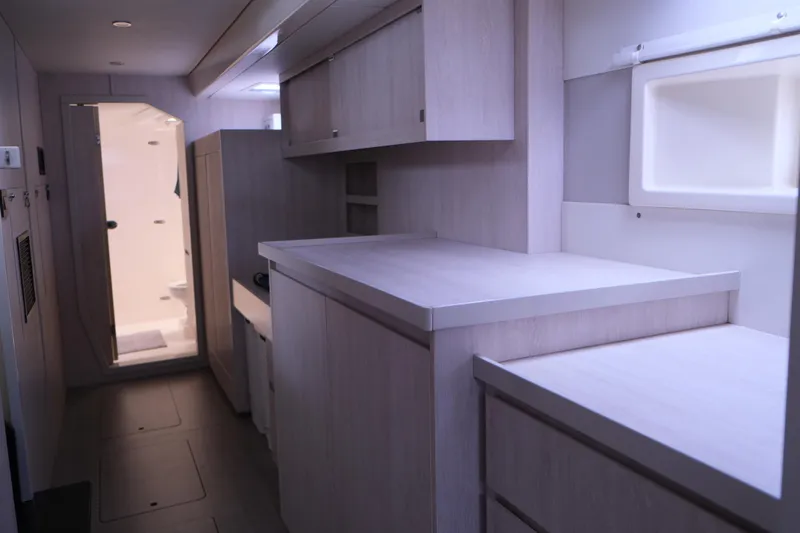 Jolly Dacha Yacht Photos Pics Modern kitchen interior of 2015 Leopard 48 yacht with sleek cabinetry and ample counter space.