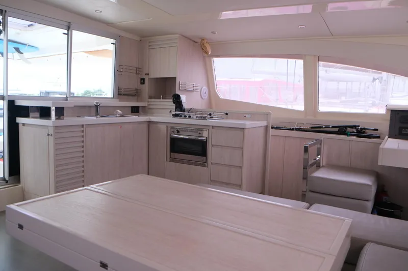 Jolly Dacha Yacht Photos Pics Modern kitchen interior on 2015 Leopard 48 yacht with light wood finish.