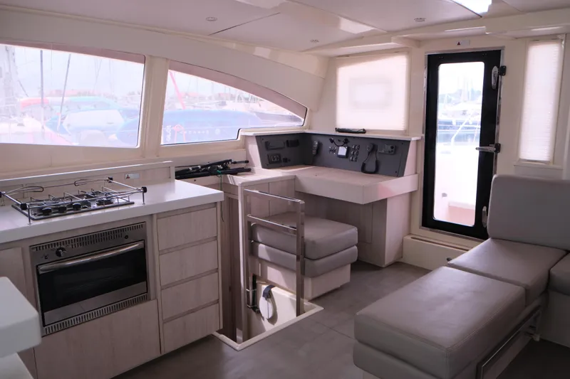 Jolly Dacha Yacht Photos Pics Modern interior of 2015 Leopard 48 yacht with kitchen and seating area.