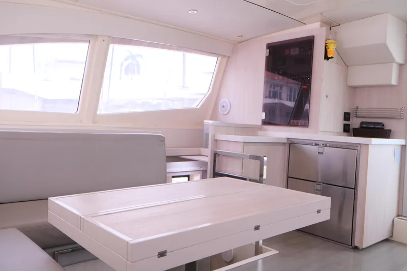 Jolly Dacha Yacht Photos Pics Modern interior of 2015 Leopard 48 yacht with sleek kitchen and dining area.