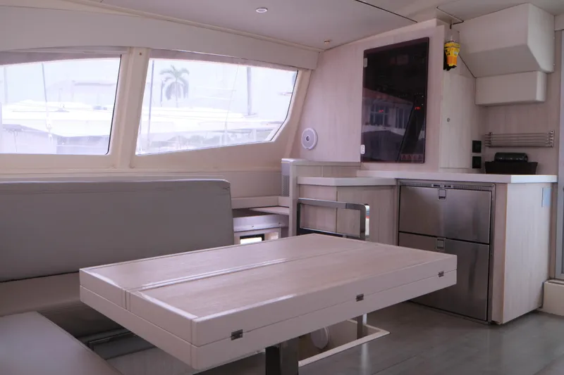 Jolly Dacha Yacht Photos Pics Modern interior of 2015 Leopard 48 yacht with dining area and kitchenette.