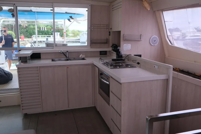 Jolly Dacha Yacht Photos Pics Modern kitchen interior on 2015 Leopard 48 yacht, featuring sleek countertops and appliances.