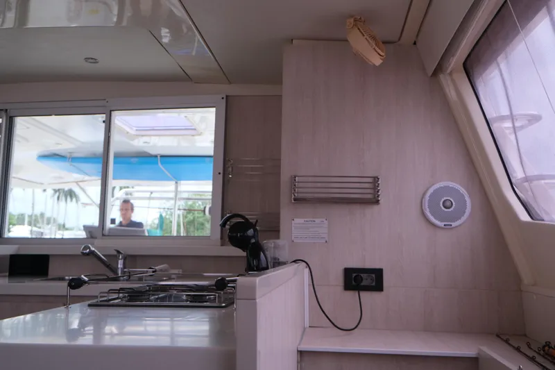 Jolly Dacha Yacht Photos Pics Interior of 2015 Leopard 48 yacht kitchen with stove, window, and modern fixtures.