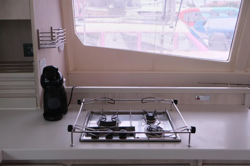 Jolly Dacha Yacht Photos Pics Compact kitchen in 2015 Leopard 48 yacht with stove and coffee maker.