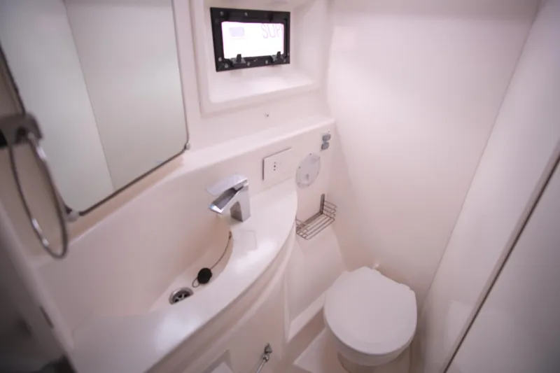 Jolly Dacha Yacht Photos Pics Compact bathroom in 2015 Leopard 48 yacht with sink, toilet, and mirror.