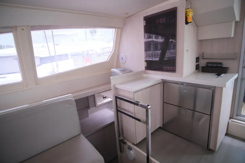 Jolly Dacha Yacht Photos Pics Modern kitchen interior of 2015 Leopard 48 yacht with sleek cabinetry and large windows.