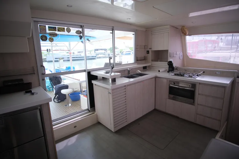 Jolly Dacha Yacht Photos Pics Modern kitchen interior on 2015 Leopard 48 yacht with marina view.