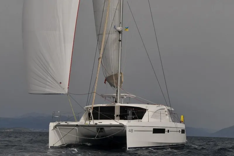 Jolly Dacha Yacht Photos Pics 2015 Leopard 48 catamaran sailing on open water.