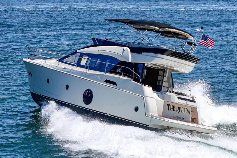 The Riviera Yacht Photos Pics 2017 Monte Carlo MC5S yacht cruising on open water with American flag.