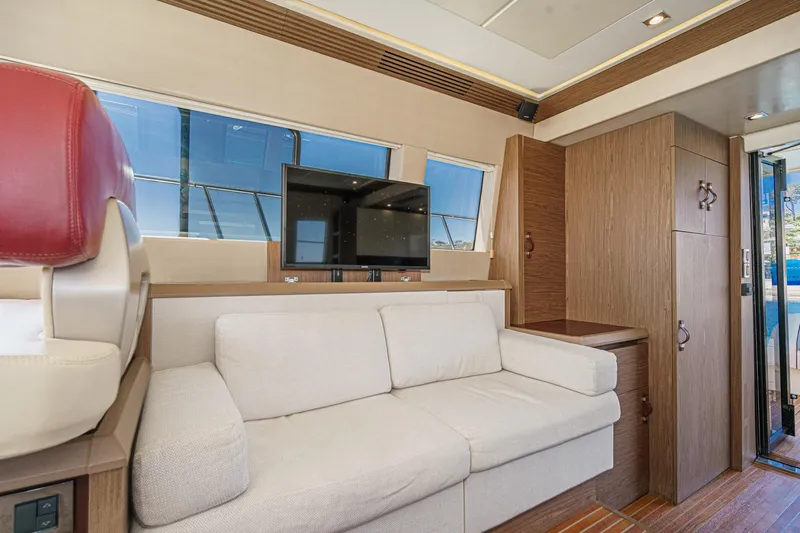 The Riviera Yacht Photos Pics Luxurious 2017 Monte Carlo MC5S yacht interior with beige sofa and mounted TV.