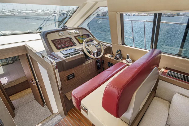 The Riviera Yacht Photos Pics Interior of 2017 Monte Carlo MC5S yacht helm with modern controls and red seating.