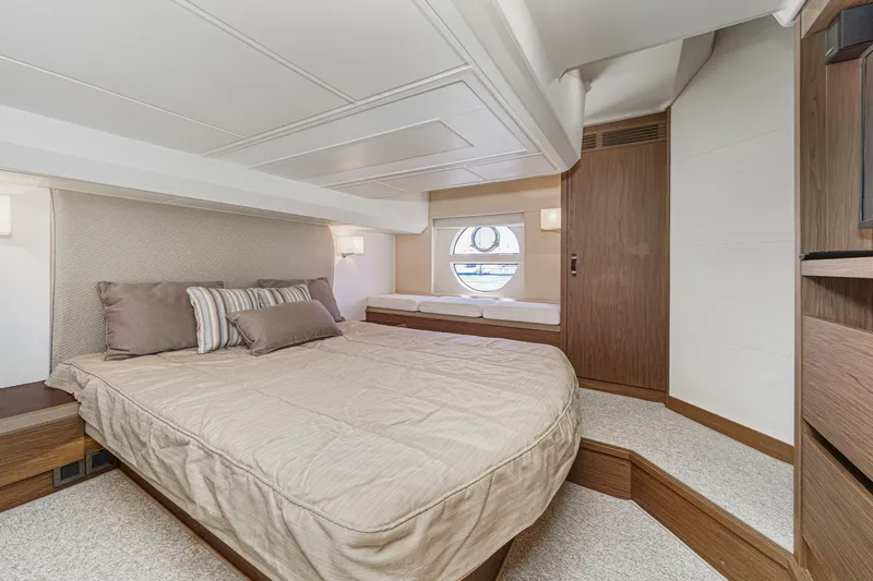 The Riviera Yacht Photos Pics Luxurious 2017 Monte Carlo MC5S yacht bedroom with elegant decor and circular window.