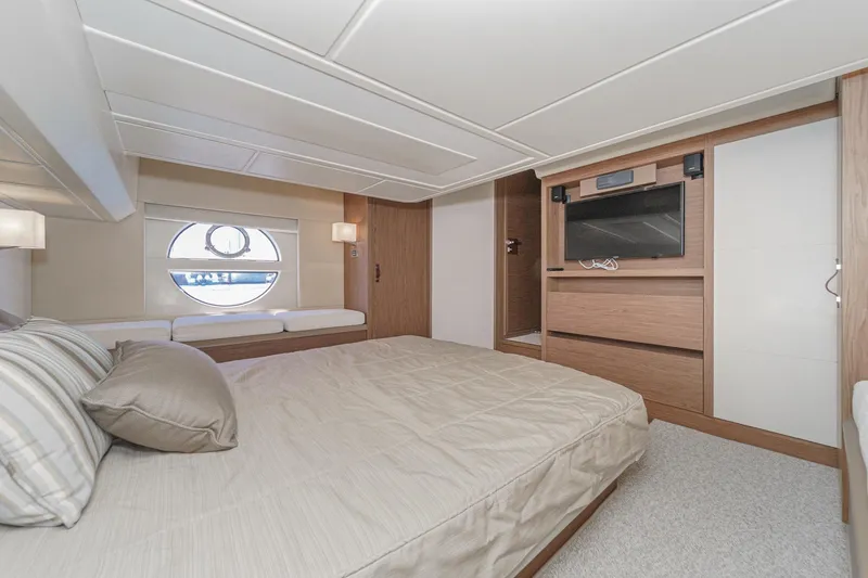 The Riviera Yacht Photos Pics Luxurious 2017 Monte Carlo MC5S yacht bedroom with modern decor and circular window.