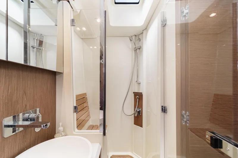 The Riviera Yacht Photos Pics Luxurious bathroom in 2017 Monte Carlo MC5S yacht with modern shower and wooden accents.