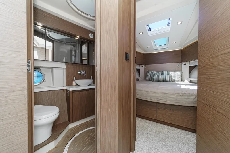 The Riviera Yacht Photos Pics Luxurious interior of 2017 Monte Carlo MC5S yacht featuring bedroom and bathroom.